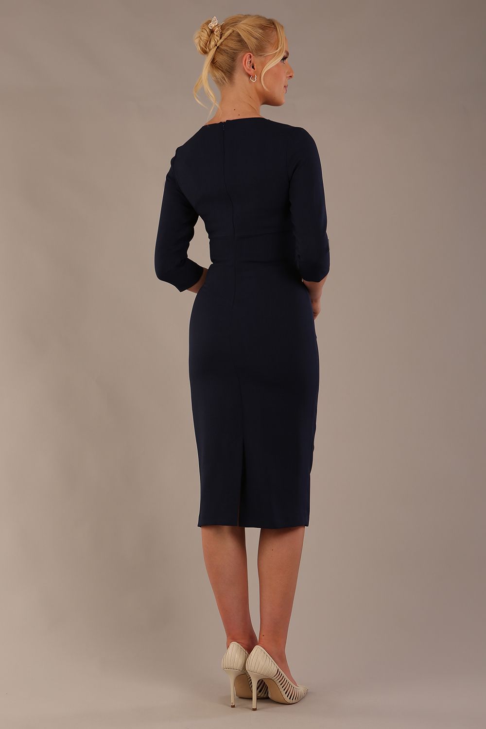 model is wearing the Diva Catwalk Ubrique pencil dress with Long sleeves and keyhole detail in Navy Blue fabric colour (Navy)
