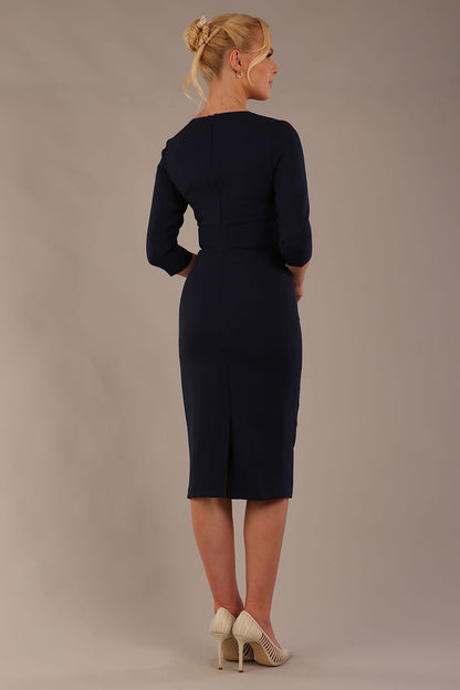 model is wearing the Diva Catwalk Ubrique pencil dress with Long sleeves and keyhole detail in Navy Blue fabric colour (Navy)