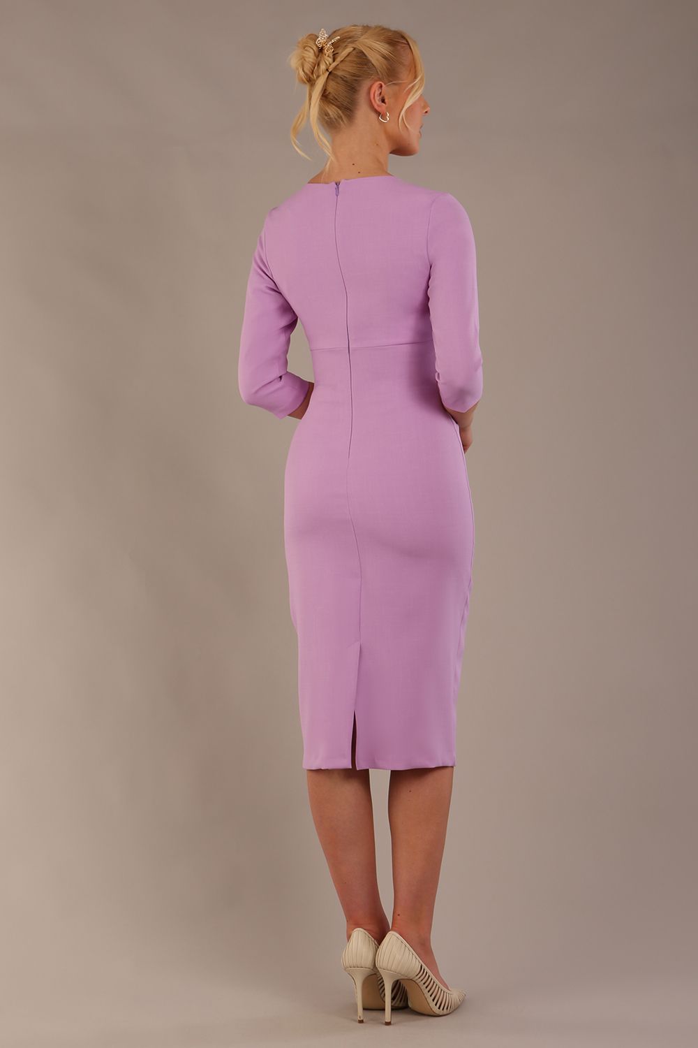 The model is wearing the Diva Catwalk Ubrique pencil dress with Long sleeves and keyhole detail in Sheer Lilac fabric colour (Sheer Lilac)