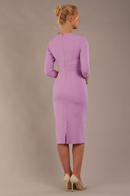 The model is wearing the Diva Catwalk Ubrique pencil dress with Long sleeves and keyhole detail in Sheer Lilac fabric colour (Sheer Lilac)