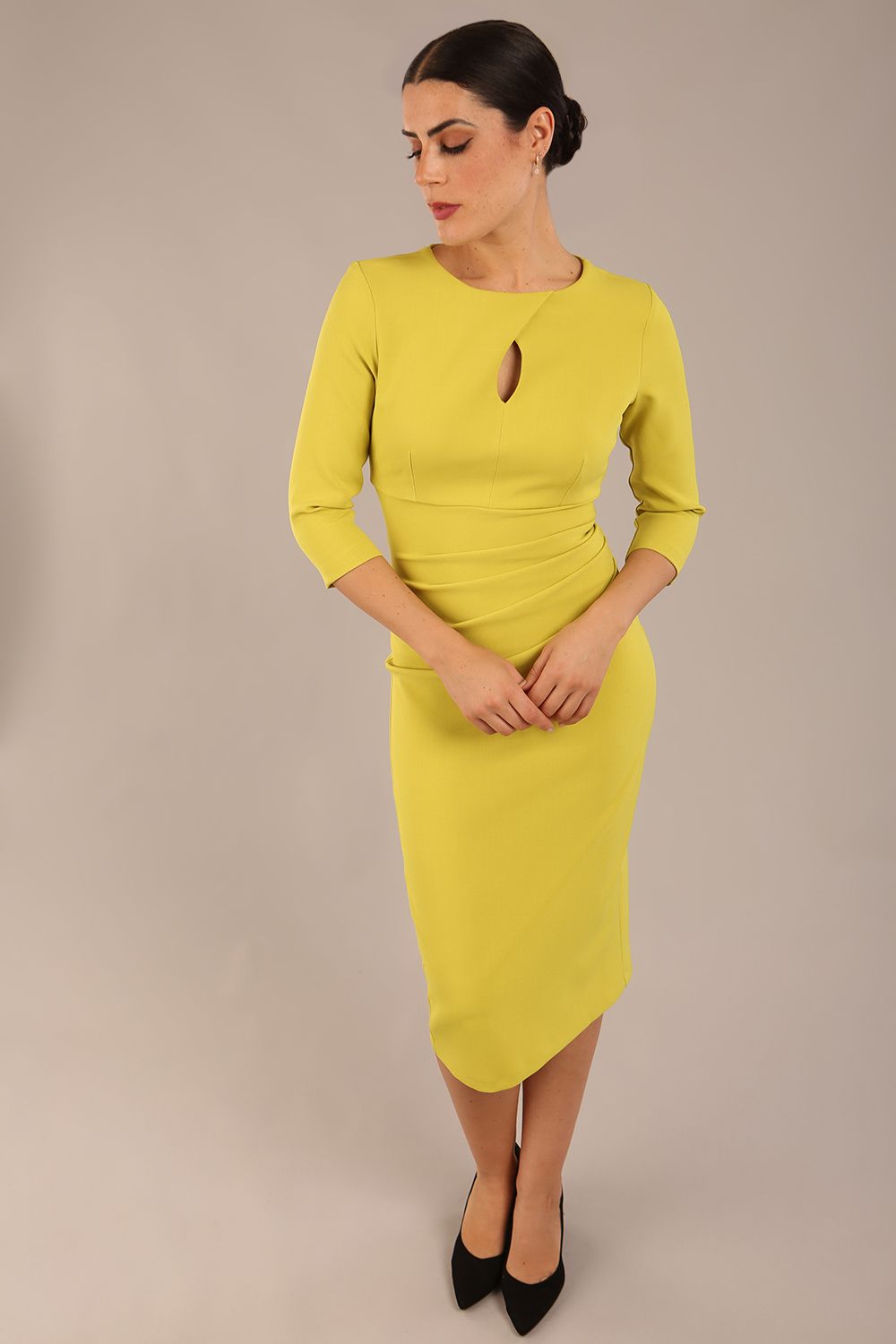 model is wearing the Diva Catwalk Ubrique pencil dress with Long sleeves and keyhole detail in Citrus Green fabric colour front (Citrus Green)