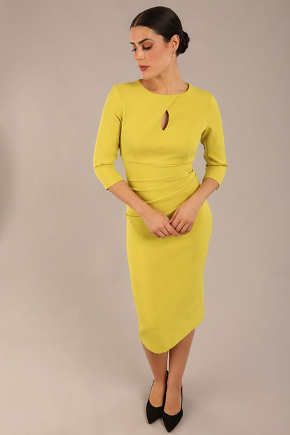 model is wearing the Diva Catwalk Ubrique pencil dress with Long sleeves and keyhole detail in Citrus Green fabric colour front (Citrus Green)