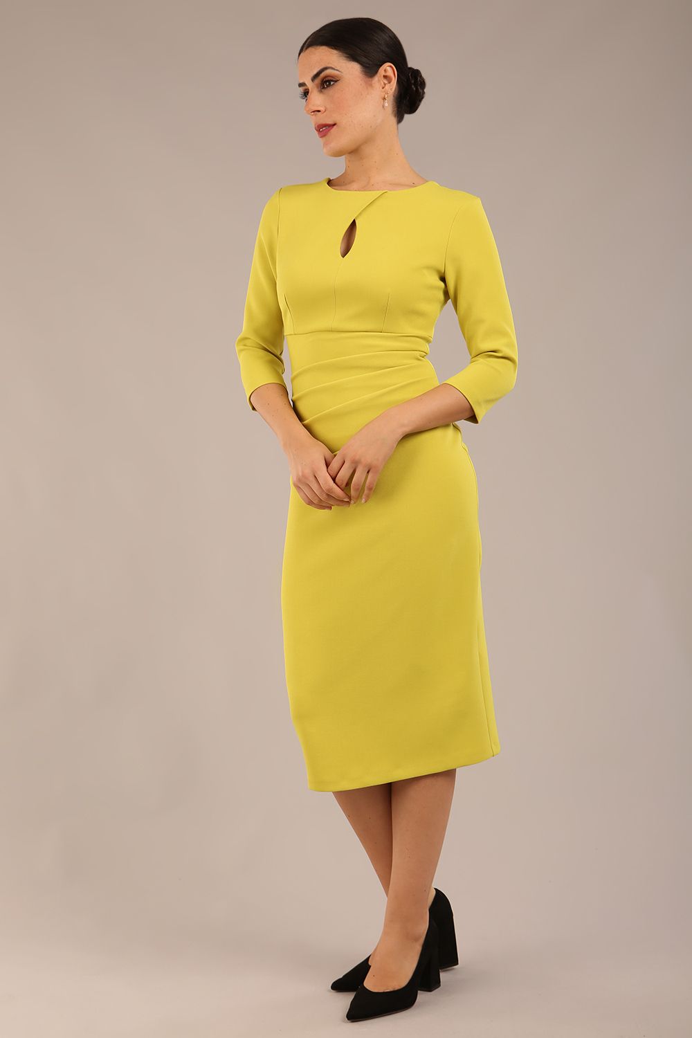 model is wearing the Diva Catwalk Ubrique pencil dress with Long sleeves and keyhole detail in Citrus Green fabric colour front (Citrus Green)