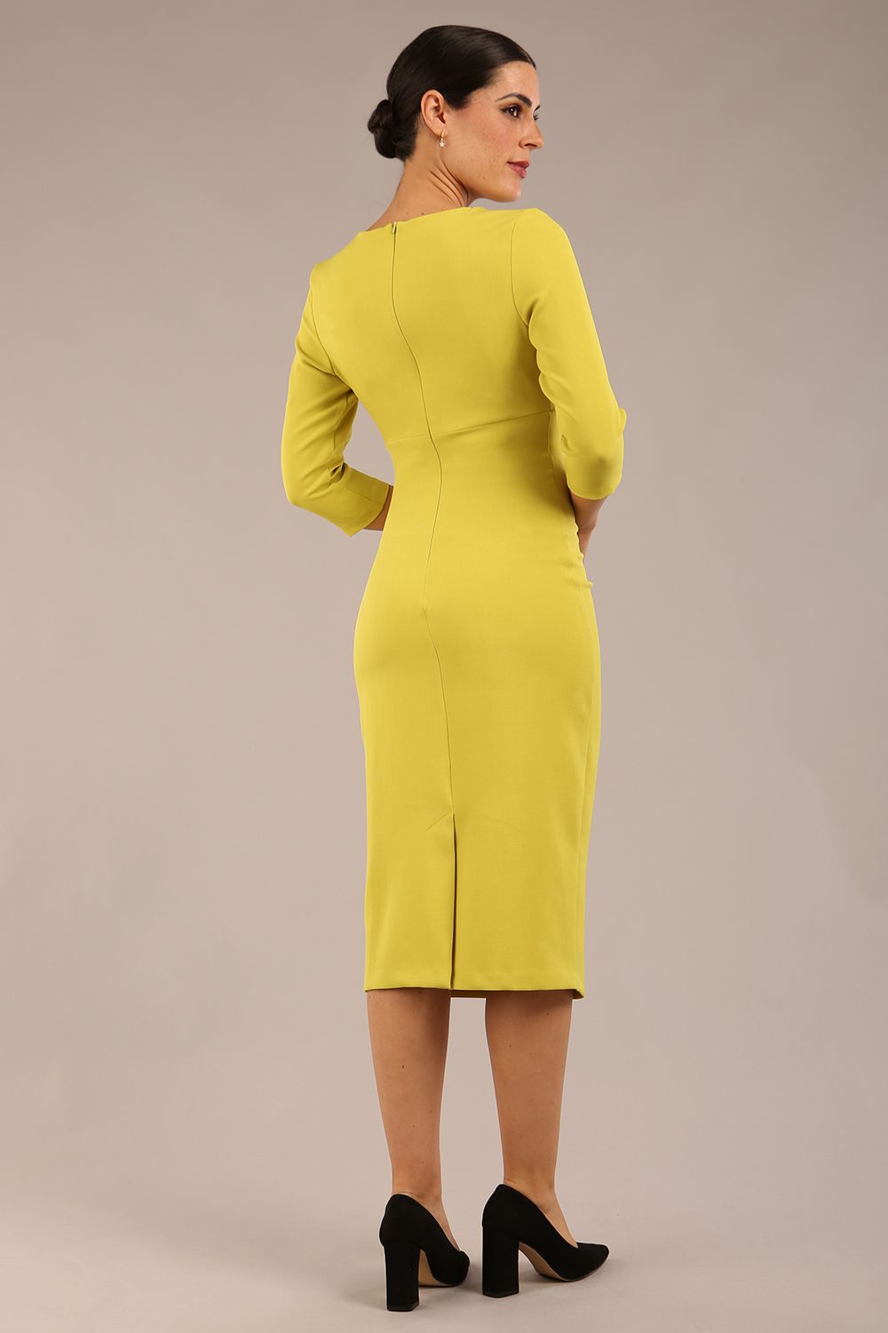 model is wearing the Diva Catwalk Ubrique pencil dress with Long sleeves and keyhole detail in Citrus Green fabric colour front (Citrus Green)