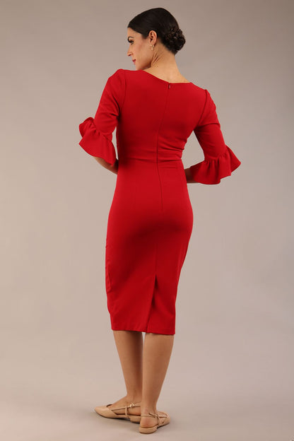 brunette model is wearing diva catwalk hollie pencil dress with frilled flute sleeve and low v-neck cut in scarlet red front close up