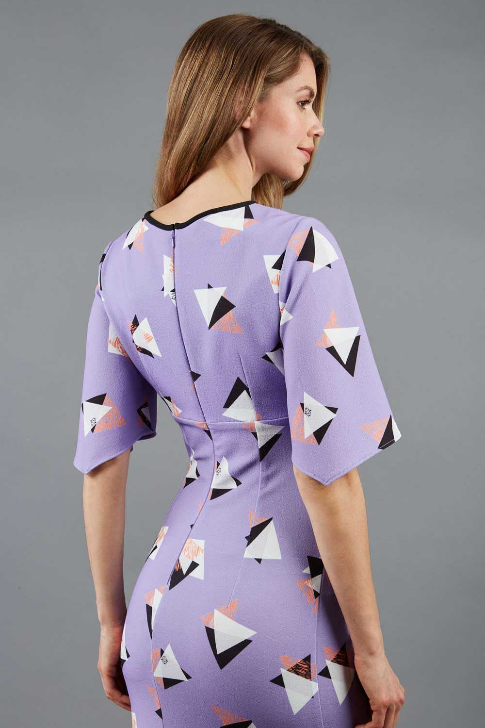 Model wearing the Diva Memphis Print dress dress in pencil dress design in diva triangle print front image