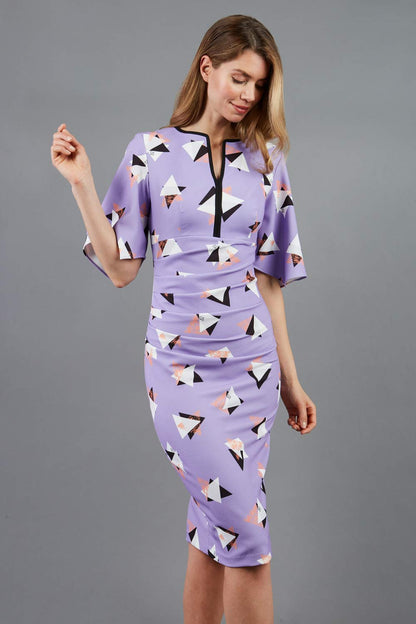 Model wearing the Diva Memphis Print dress dress in pencil dress design in diva triangle print front image
