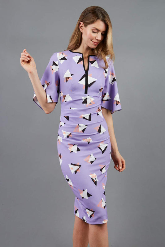 Model wearing the Diva Memphis Print dress dress in pencil dress design in diva triangle print front image