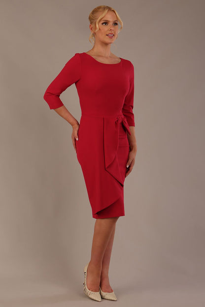 model is wearing diva catwalk jacky dress with rounded neckline 3/4 sleeve and bow detail on the waist in Dazzle pink front view (Dazzle Pink)