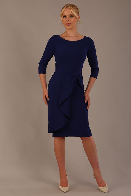 model is wearing diva catwalk jacky dress with rounded neckline 3/4 sleeve and bow detail on the waist in oxford blue front view (Oxford Blue)