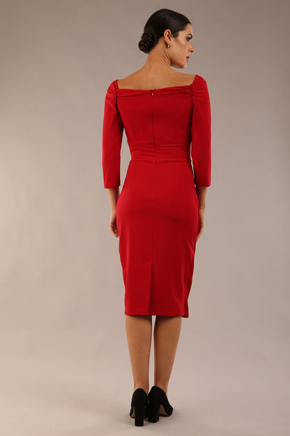 brunette model wearing diva catwalk evening pencil dress off shoulder with sleeves and pleated pencil skirt in colour scarlet red front