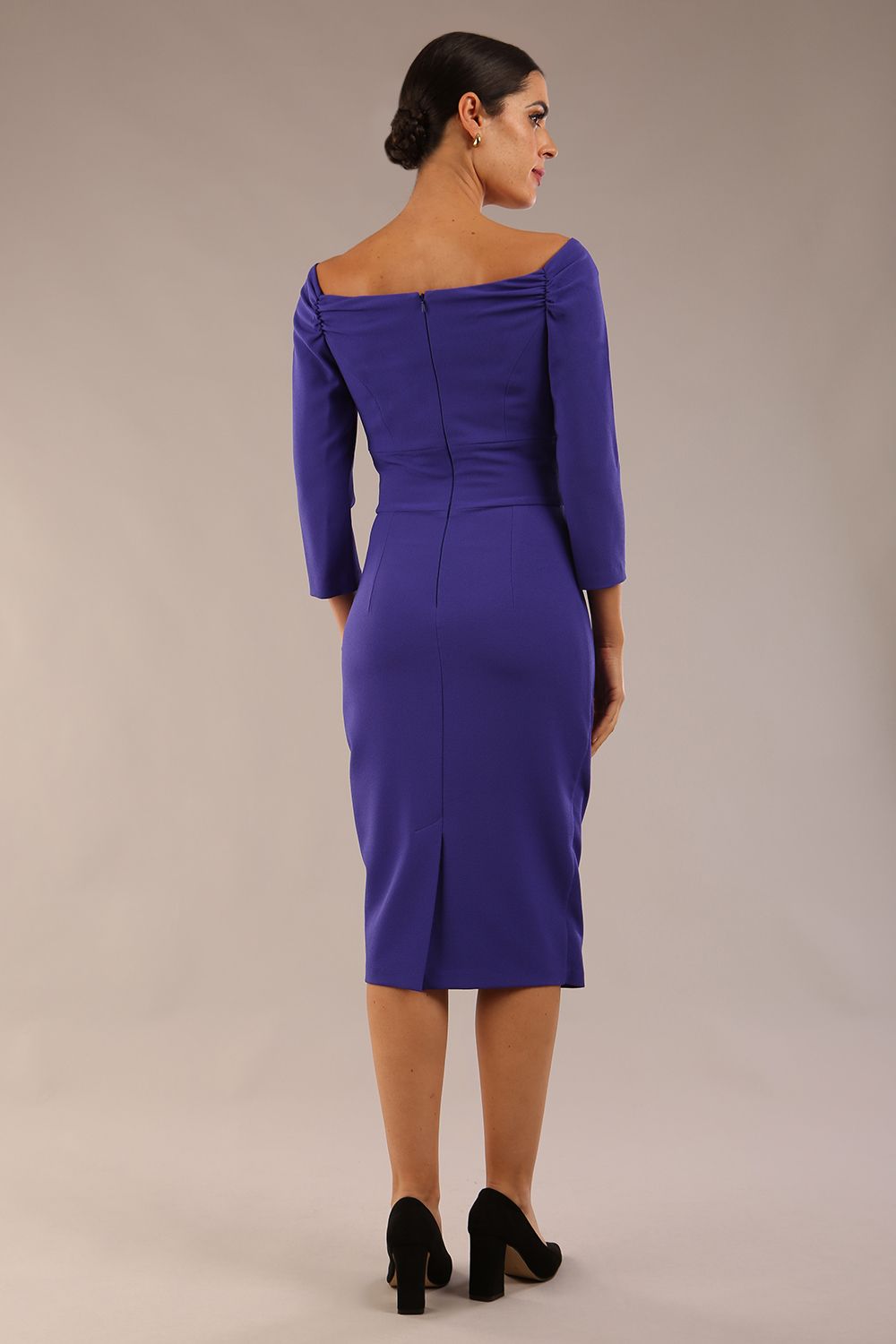 brunette model wearing diva catwalk evening pencil dress off shoulder with sleeves and pleated pencil skirt in colour indigo blue front