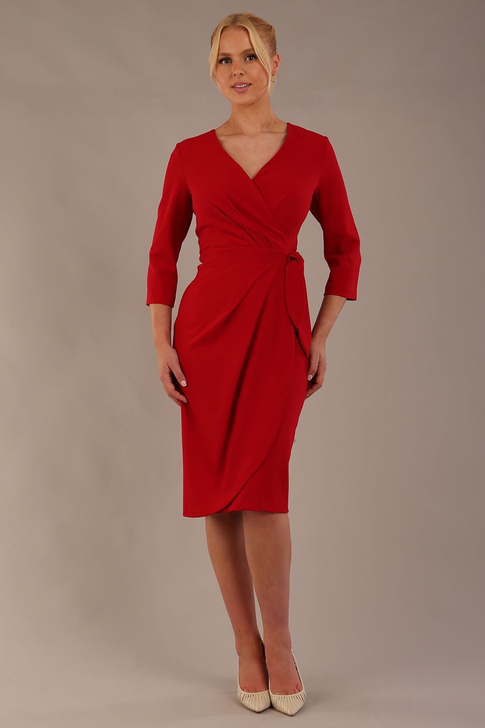 model wearing diva catwalk elan elegant red dress with 3 4 sleeves with a tie detail and asymmetrical closing front (Scarlet Red)