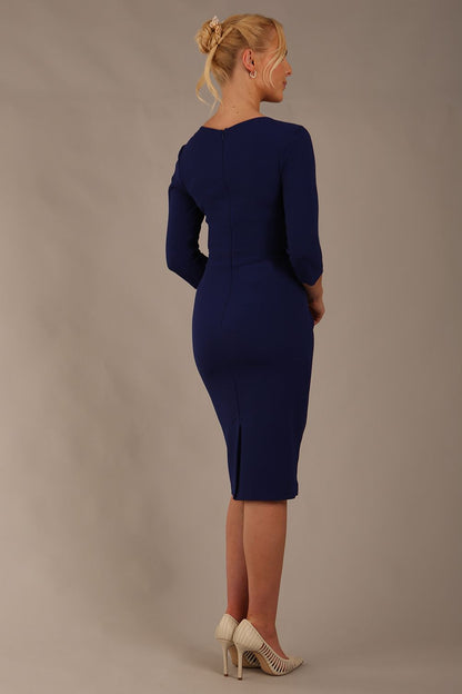 model wearing diva pencil dress tulip design with overlapping pencil skirt with 3 4 sleeves in colour oxford blue front (Oxford Blue)
