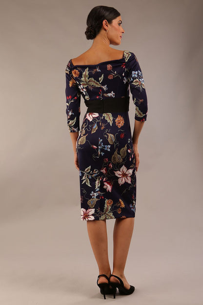 model wears Alpa Print off the shoulder pencil sheath Dress with long sleeves back image in wildflower print