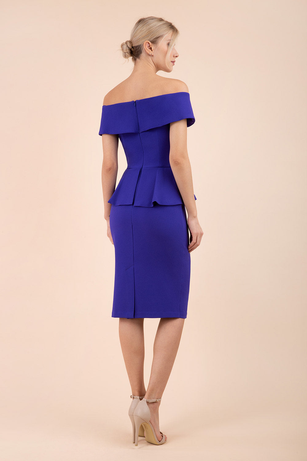 blonde model wearing diva catwalk peplum pencil skirt dress in spectrum indigo