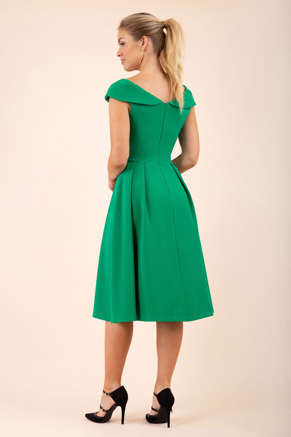blonde model wearing diva catwalk Chesterton a-line skirt Swing Sleeveless dress in emerald green front
