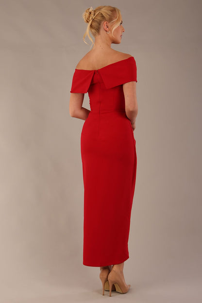 model wearing diva catwalk vegas calf length midaxi dress with wide bardot neckline and open shoulders with a large opening at the front of the skirt with pleating coming down long skirt front in scarlet red (Scarlet Red)