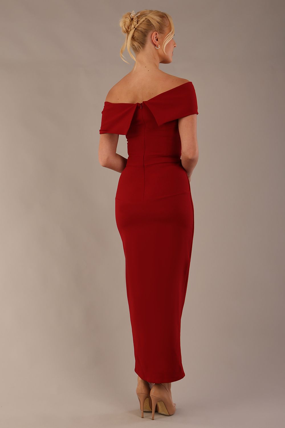 model wearing diva catwalk vegas calf length rosewood red midaxi dress with wide bardot neckline and open shoulders with a large opening at the front of the skirt with pleating coming down long skirt front (Rosewood Red)