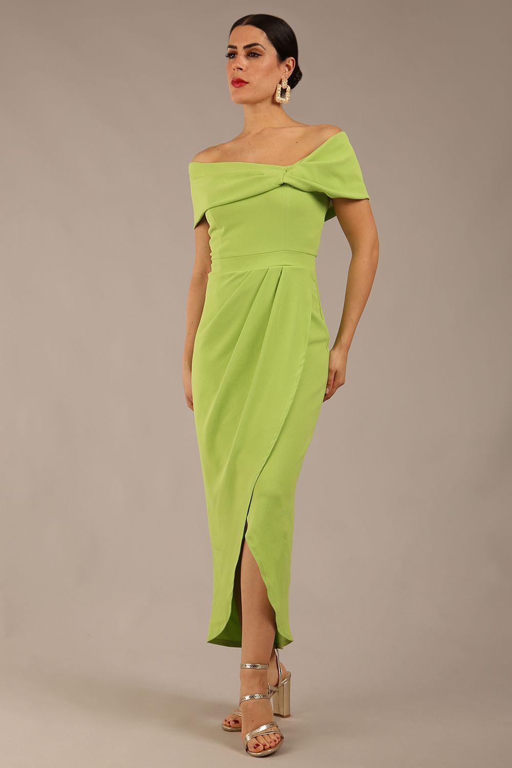 brunette model wearing diva catwalk vegas calf length lime green midaxi dress with wide bardot neckline and open shoulders with a large opening at the front of the skirt with pleating coming down long skirt front (Lime Green)