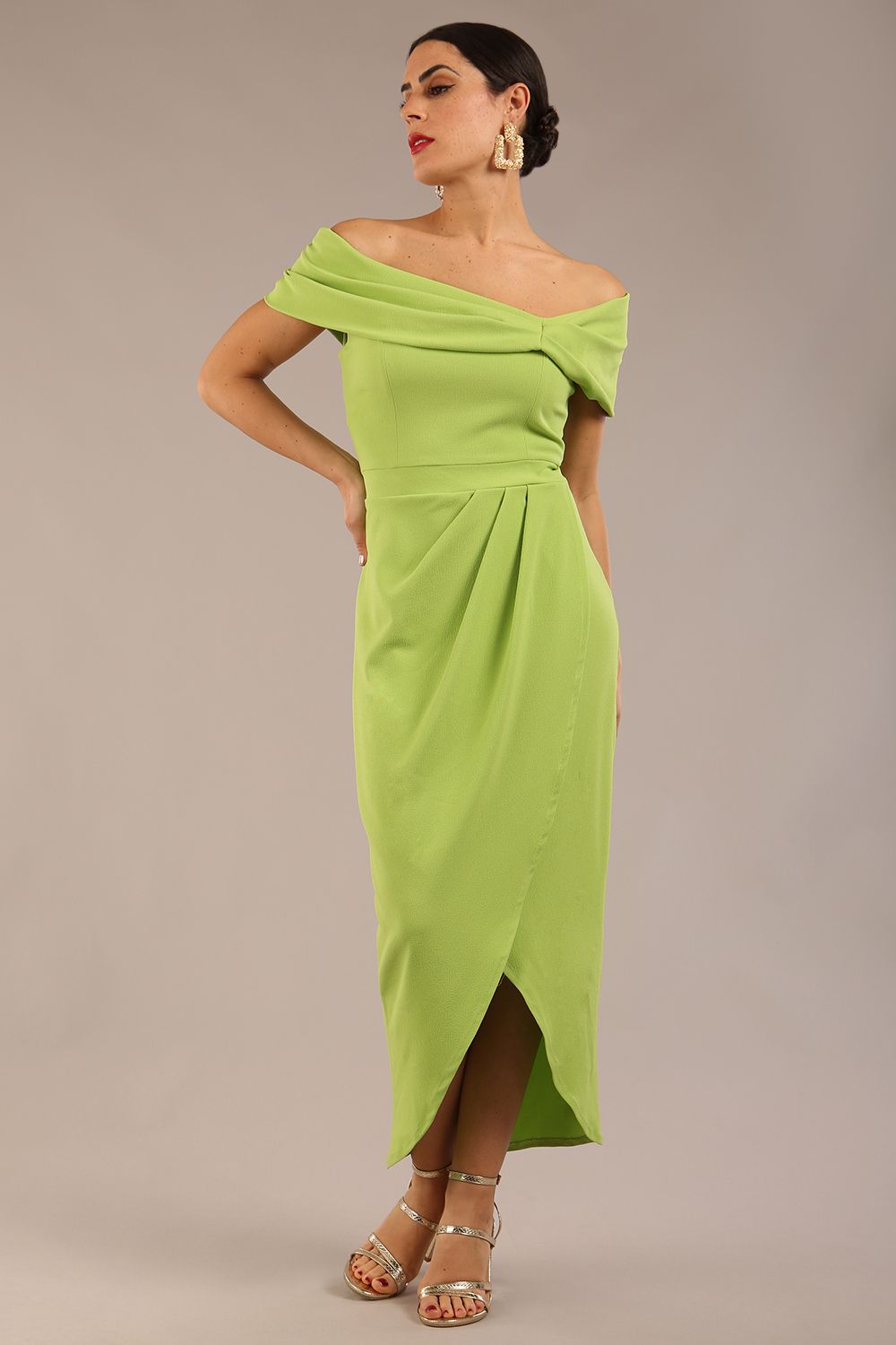 brunette model wearing diva catwalk vegas calf length lime green midaxi dress with wide bardot neckline and open shoulders with a large opening at the front of the skirt with pleating coming down long skirt front (Lime Green)