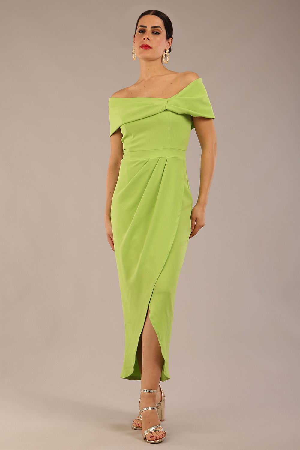 brunette model wearing diva catwalk vegas calf length lime green midaxi dress with wide bardot neckline and open shoulders with a large opening at the front of the skirt with pleating coming down long skirt front (Lime Green)