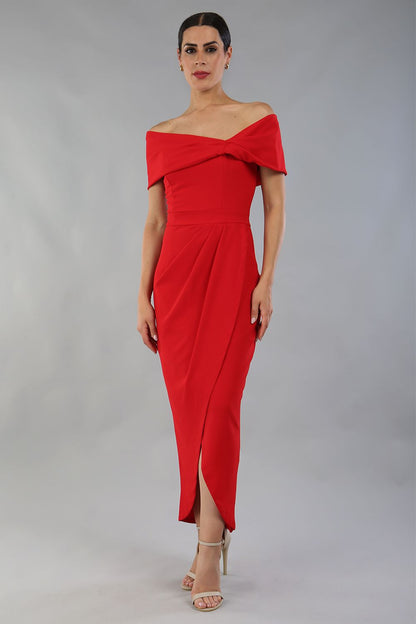 model wearing diva catwalk vegas calf length midaxi dress with wide bardot neckline and open shoulders with a large opening at the front of the skirt with pleating coming down long skirt front in scarlet red (Scarlet Red)
