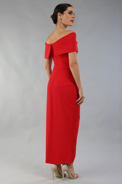 model wearing diva catwalk vegas calf length midaxi dress with wide bardot neckline and open shoulders with a large opening at the front of the skirt with pleating coming down long skirt front in scarlet red (Scarlet Red)