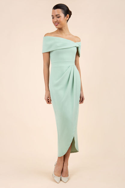 brunette model wearing diva catwalk vegas calf length pale green midaxi dress with wide bardot neckline and open shoulders with a large opening at the front of the skirt with pleating coming down long skirt front (Deco Green)