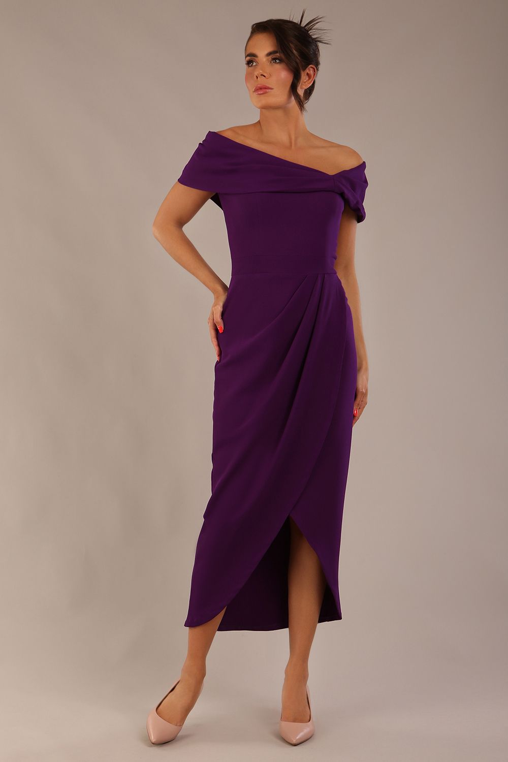 brunette model wearing diva catwalk vegas calf length passion purple midaxi dress with wide bardot neckline and open shoulders with a large opening at the front of the skirt with pleating coming down long skirt front (Passion Purple)