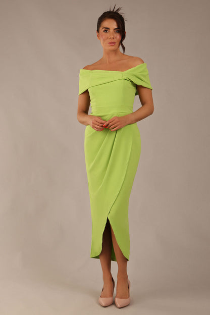 brunette model wearing diva catwalk vegas calf length lime green midaxi dress with wide bardot neckline and open shoulders with a large opening at the front of the skirt with pleating coming down long skirt front (Lime Green)