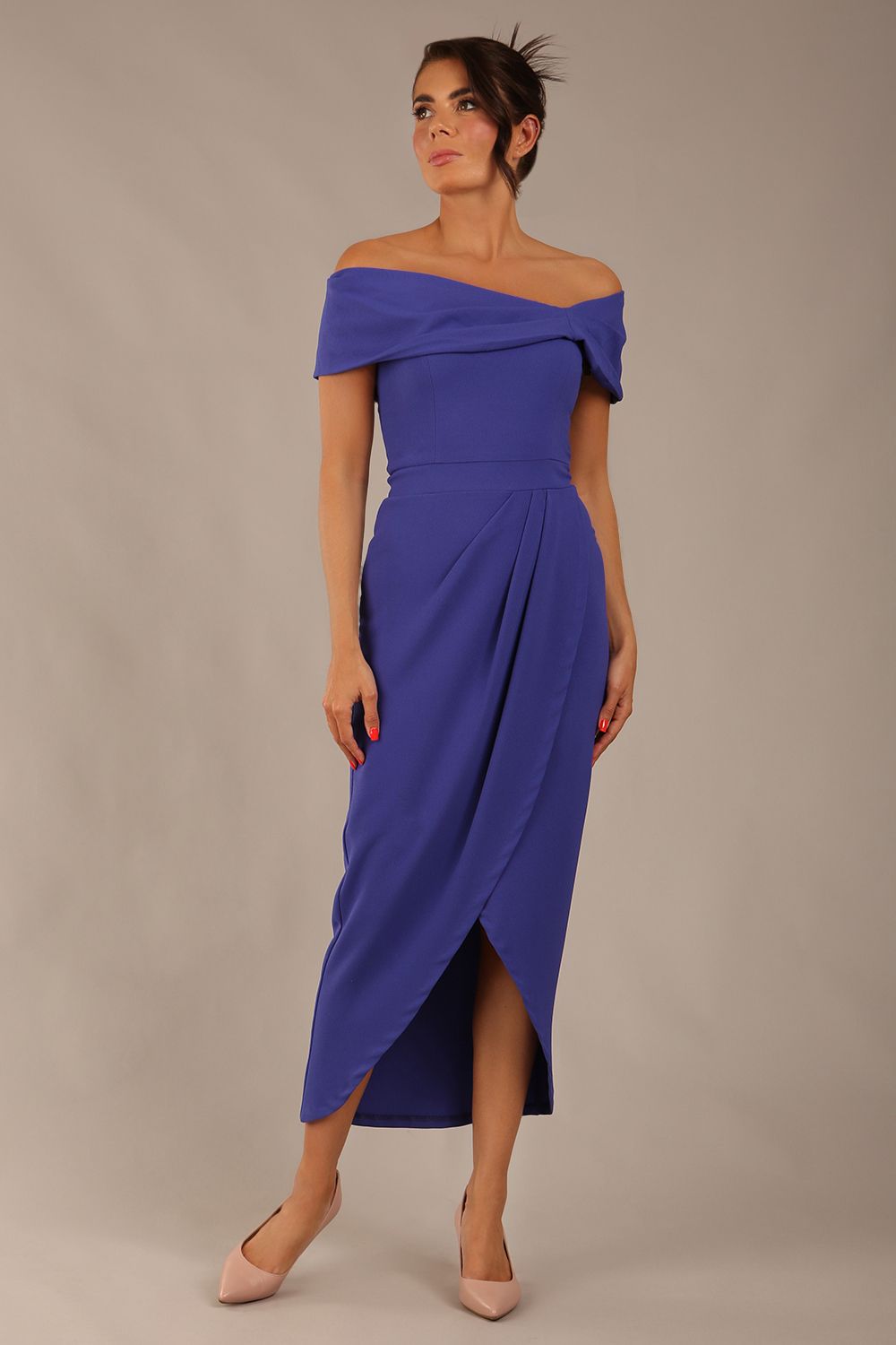 model wearing diva catwalk vegas calf length spectrum indigo midaxi dress with wide bardot neckline and open shoulders with a large opening at the front of the skirt with pleating coming down long skirt front (Spectrum Indigo)