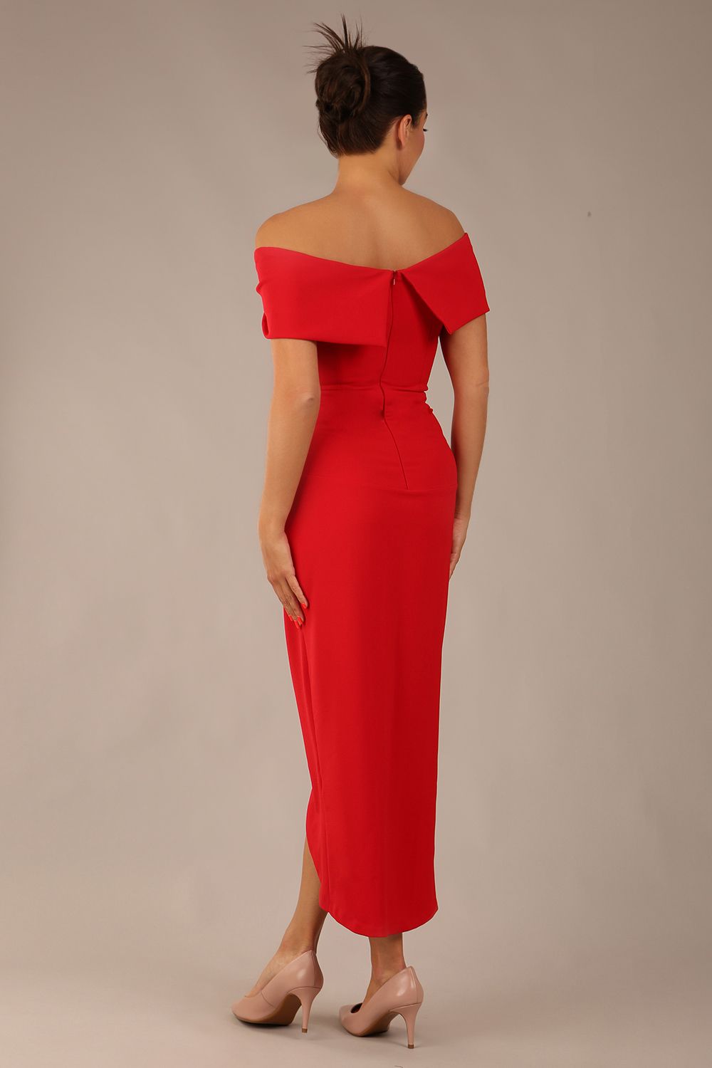 model wearing diva catwalk vegas calf length midaxi dress with wide bardot neckline and open shoulders with a large opening at the front of the skirt with pleating coming down long skirt front in scarlet red (Scarlet Red)