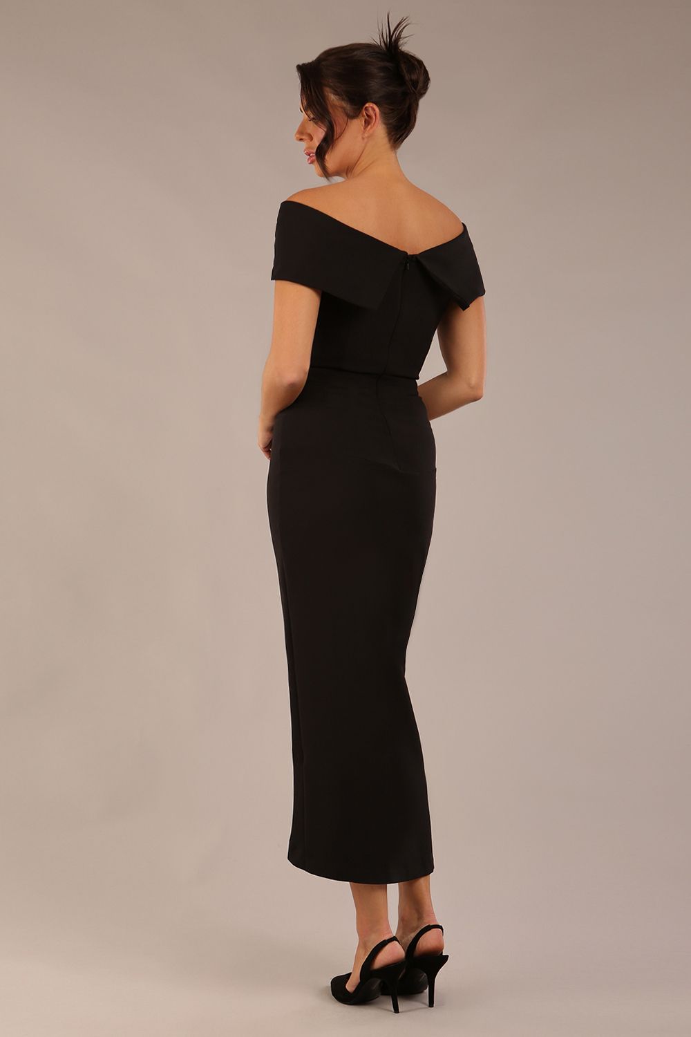 brunette model wearing diva catwalk vegas calf-length black midaxi dress with wide bardot neckline and open shoulders with a large opening at the front of the skirt with pleating coming down long skirt front (Black)