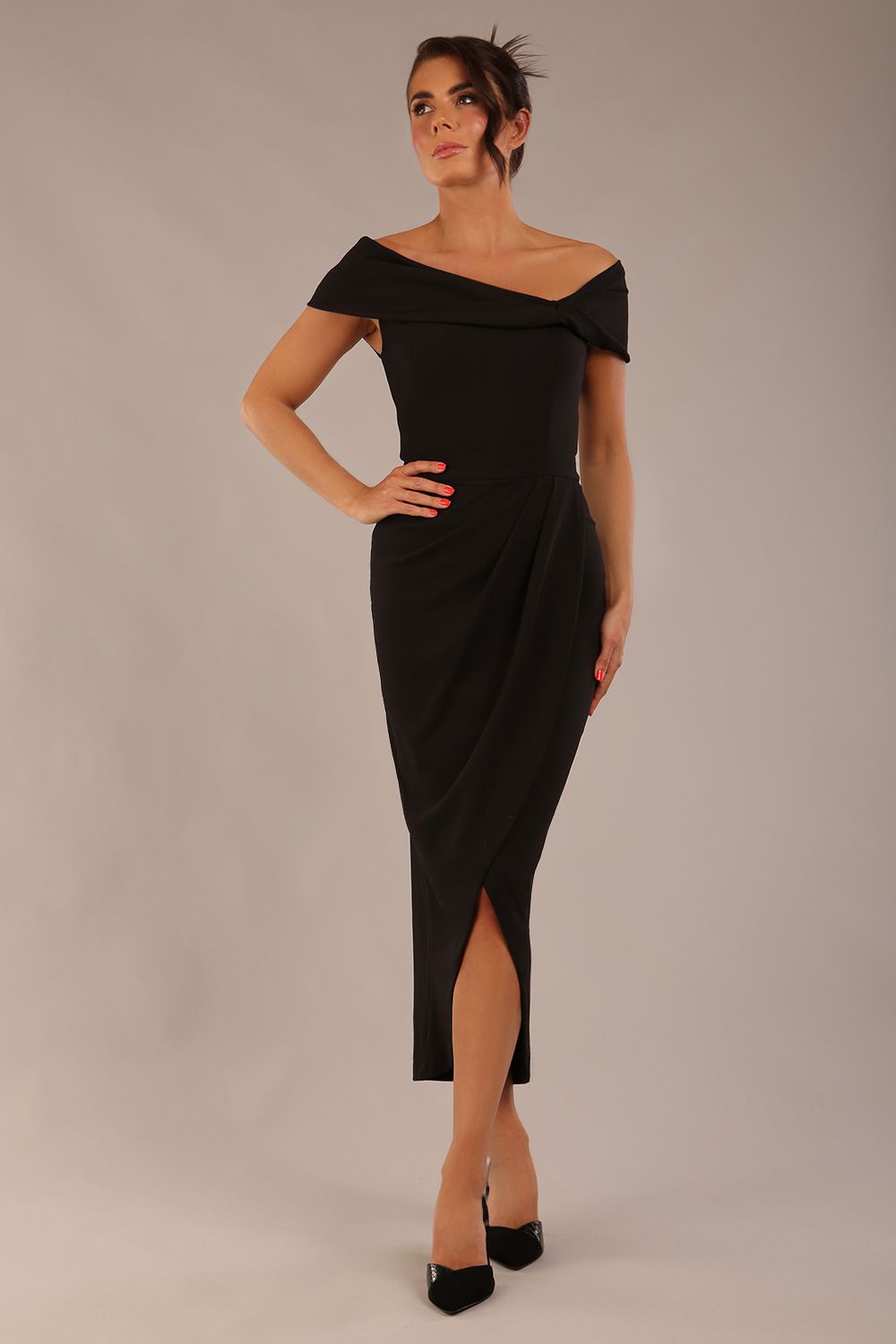 brunette model wearing diva catwalk vegas calf-length black midaxi dress with wide bardot neckline and open shoulders with a large opening at the front of the skirt with pleating coming down long skirt front (Black)