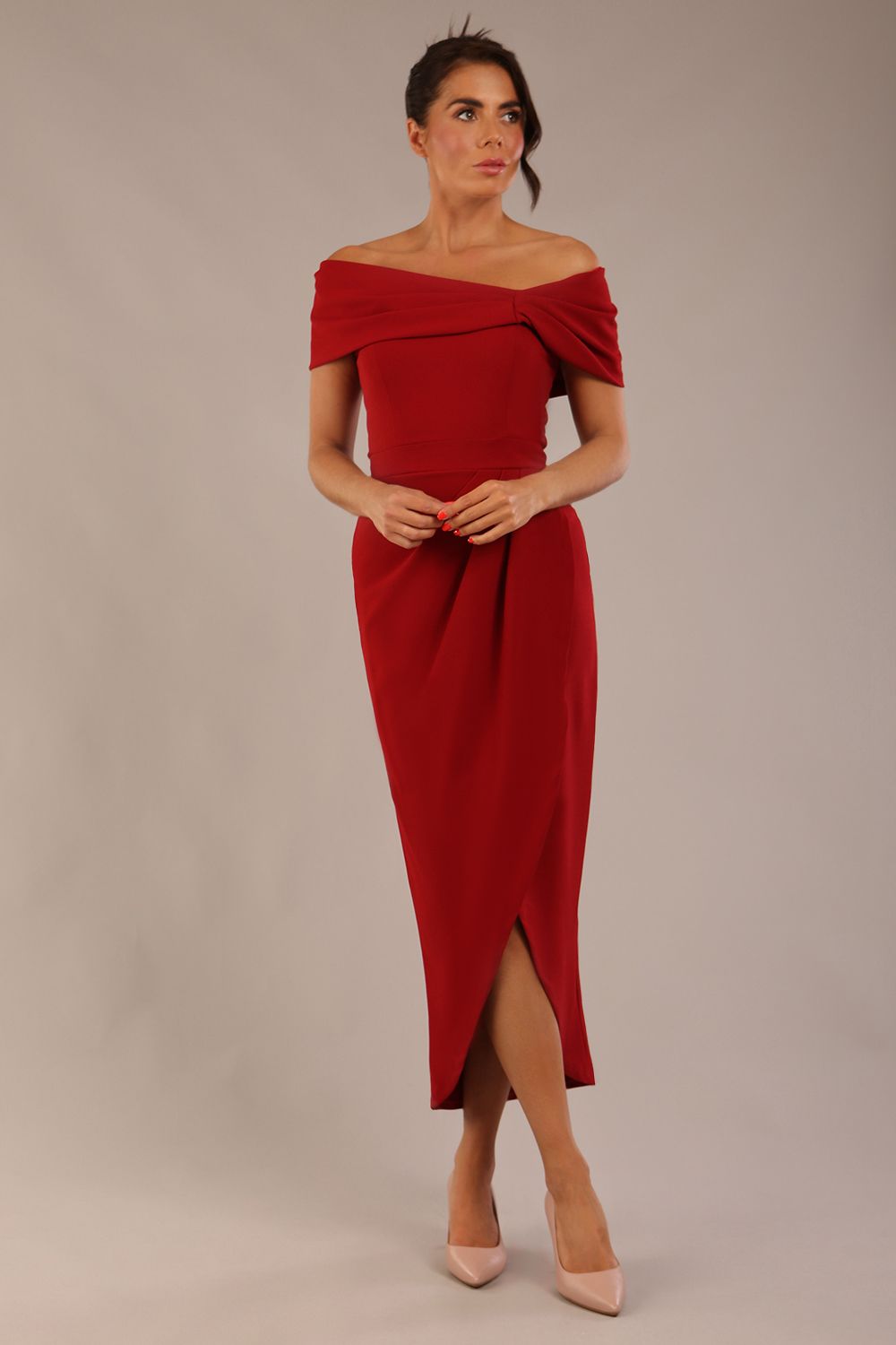 model wearing diva catwalk vegas calf length rosewood red midaxi dress with wide bardot neckline and open shoulders with a large opening at the front of the skirt with pleating coming down long skirt front (Rosewood Red)