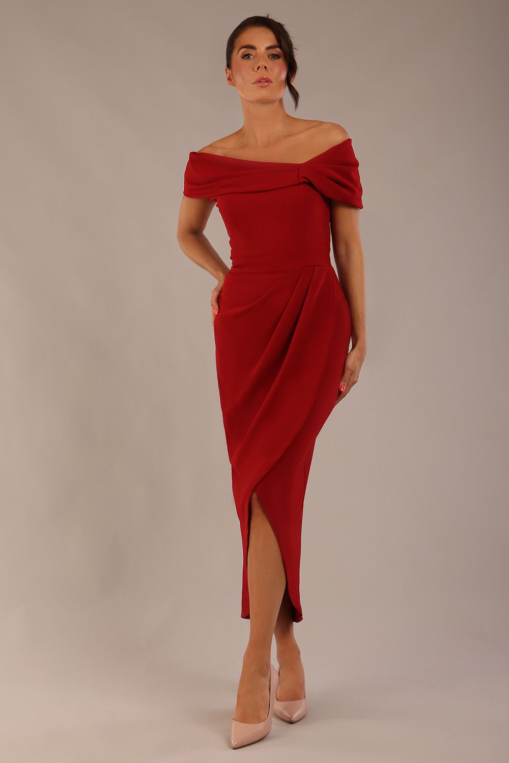 model wearing diva catwalk vegas calf length rosewood red midaxi dress with wide bardot neckline and open shoulders with a large opening at the front of the skirt with pleating coming down long skirt front (Rosewood Red)
