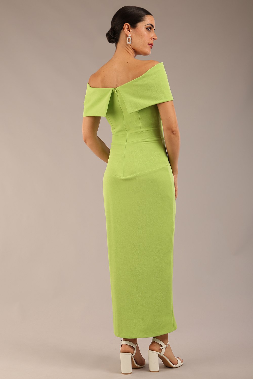 brunette model wearing diva catwalk vegas calf length lime green midaxi dress with wide bardot neckline and open shoulders with a large opening at the front of the skirt with pleating coming down long skirt front (Lime Green)