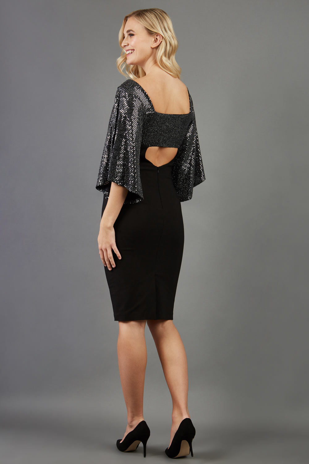 blonde model is wearing diva catwalk premiere pencil vintage sperkly dress with sleeves and empire waist in black front