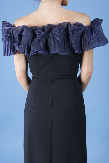 brunette model is wearing diva catwalk classique maxi black dress with off shoulder organza detail without sleeves in black and navy back