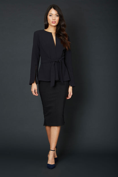 Brunette Model wearing Diva Catwalk Attimo Full length sleeve cut out back Jacket with belted waistline and sleeves with slits from elbow in Black back