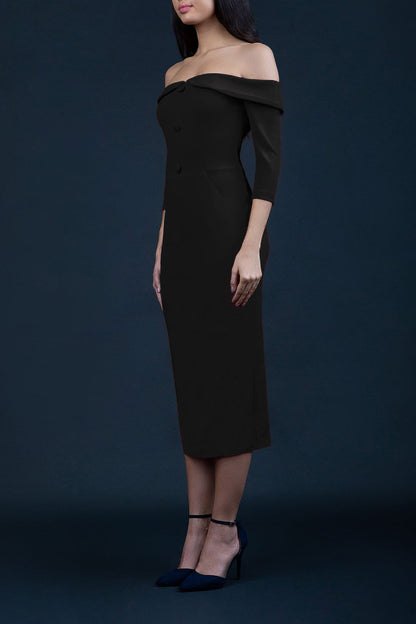 blonde model is wearing three quarter fitted dress off-shoulder with bardot neckline and buttons to front with pockets and vent on a skirt in black front