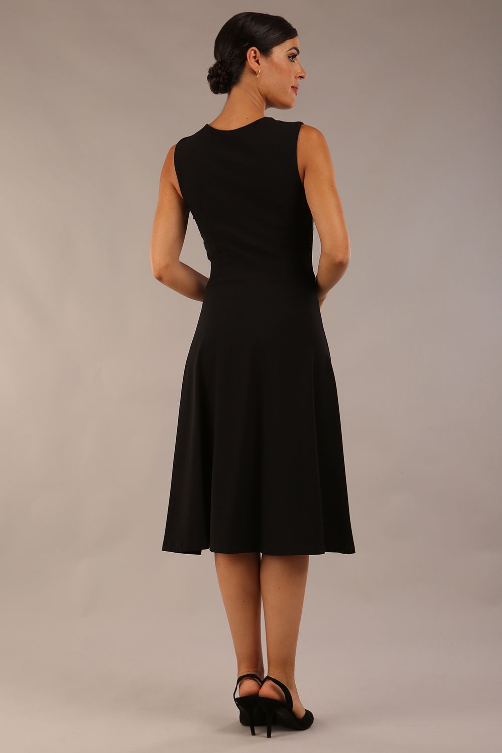 model wearing a Diva Catwalk Patina A-line Swing Sleeveless dress with v-neckline with butterfly detail in Black close up