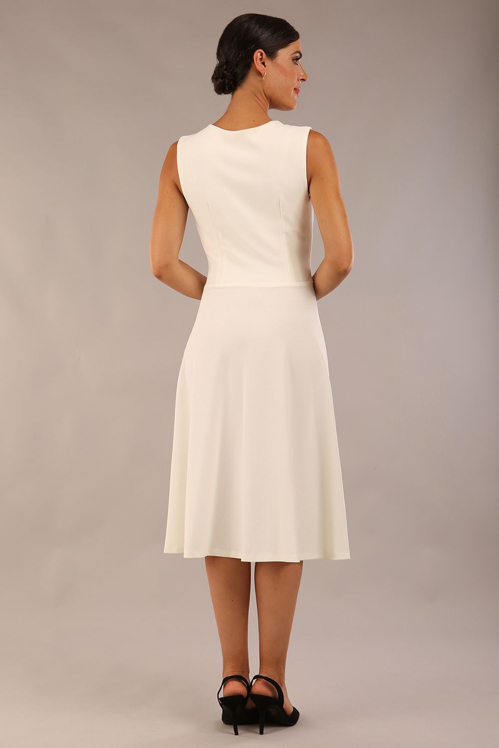 model wearing Diva Catwalk Patina A-line Swing Sleeveless dress with v-neckline with detail in Ivory-White colour 