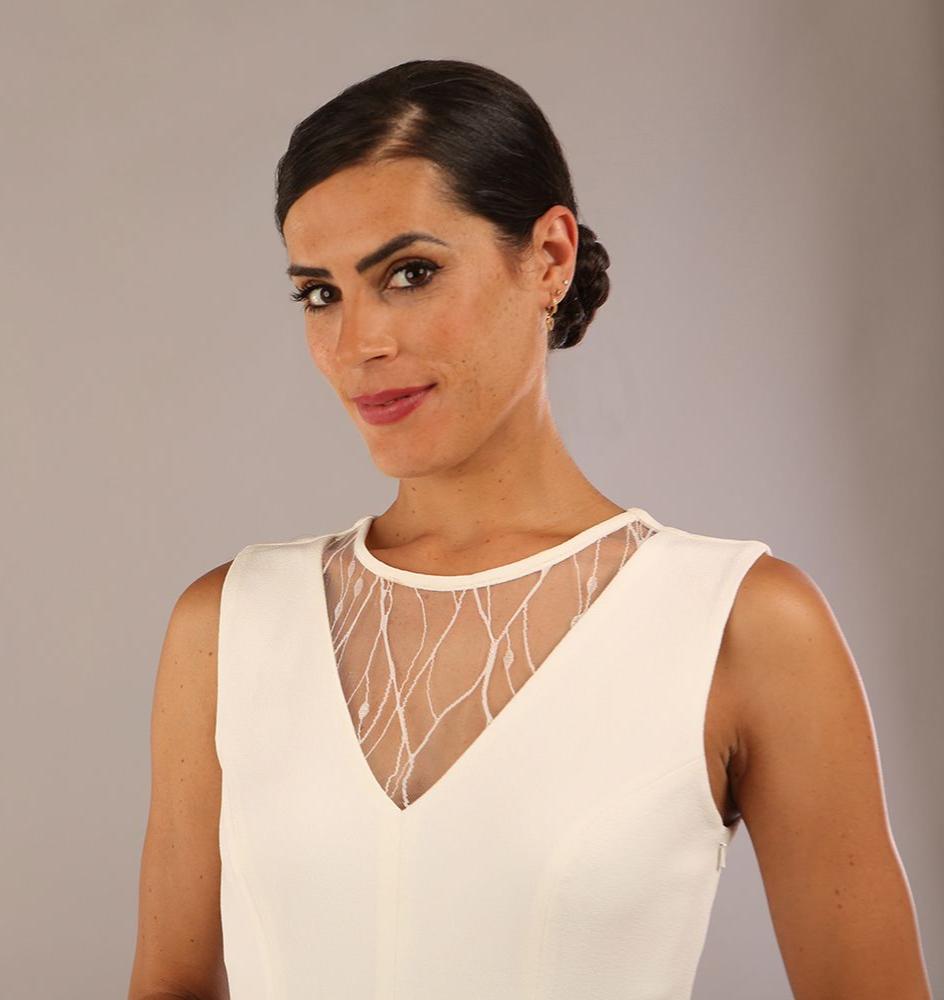 model wearing Diva Catwalk Patina A-line Swing Sleeveless dress with v-neckline with detail in Ivory-White colour 