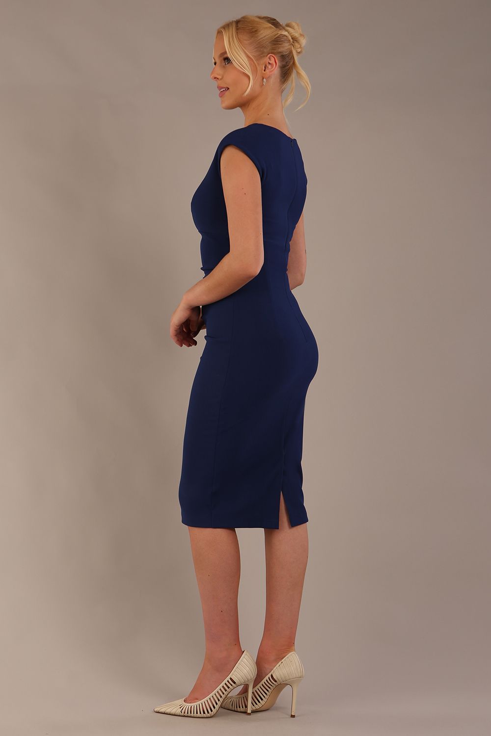 model wearing diva catwalk lydia sleeveless pencil flattering fitted plain dress with split neckline and pleating across the body in navy blue sheath dress front (Navy Blue)