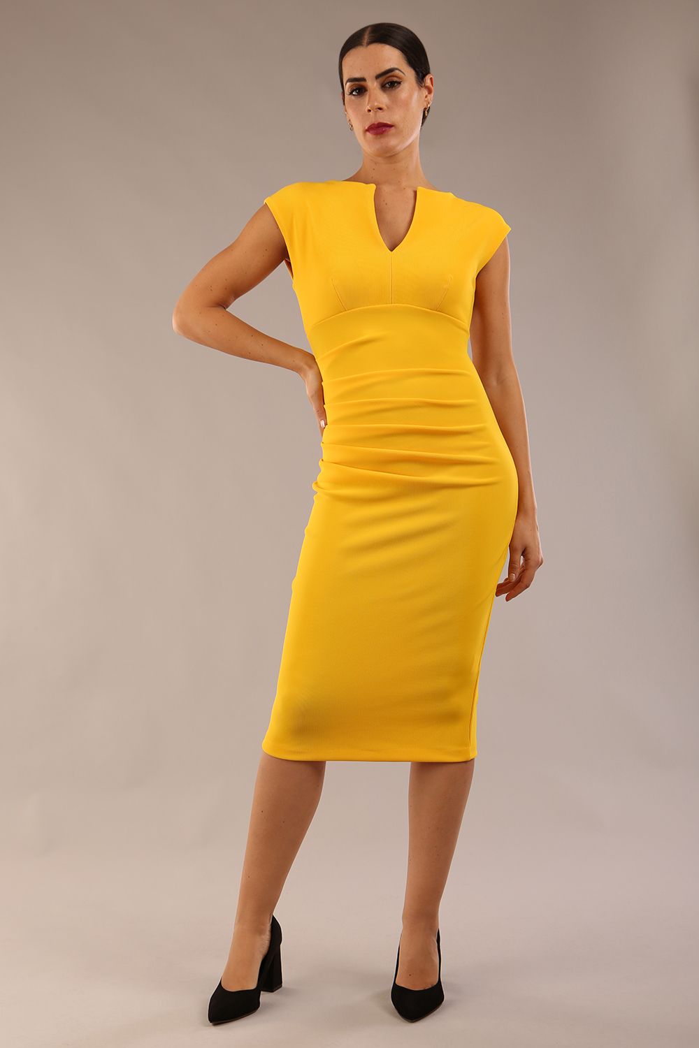 model wearing diva catwalk lydia sleeveless pencil flattering fitted plain dress with split neckline and pleating across the body in spectra yellow front (Spectra Yellow)