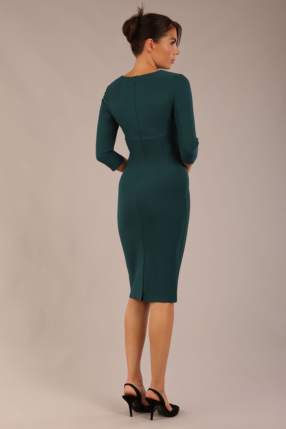 brunette model wearing a Diva Catwalk pencil three quarter sleeve dress with a split neckline and pleating across the tummy and round neck in green gables colour front