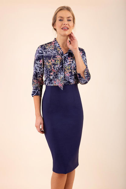 blonde model wearing seed elixir pencil knee length skirt in navy blue front