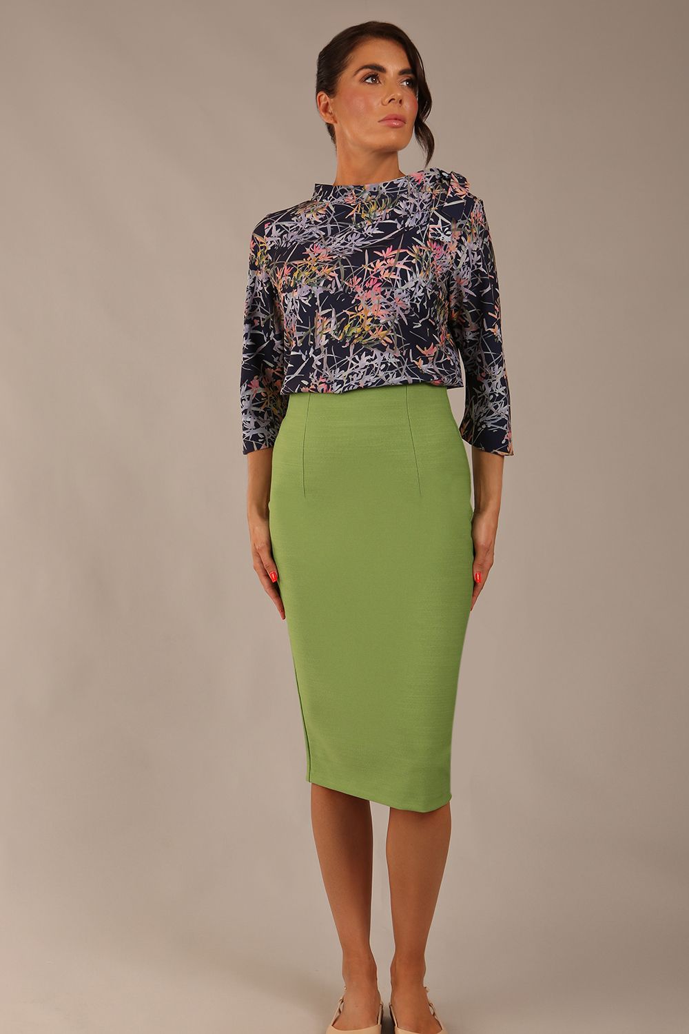 brunette model wearing a diva catwalk seed elixir pencil knee length skirt in citrus green front 